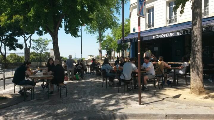 Parisians enjoy their first post-lockdown café stop above the Parc de Belleville in eastern Paris, with the Eiffel Tower in the distance.